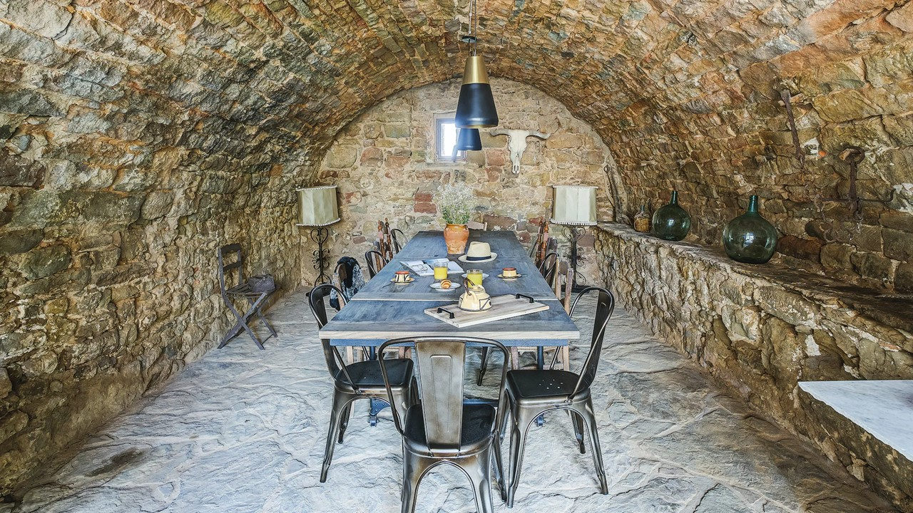 Comedor en la bodega con bóveda de piedra de la Masia de Queralt