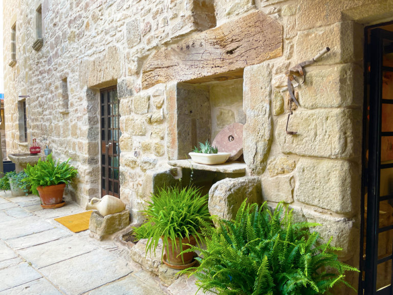 Old stone olive oil press at the farmhouse entrance