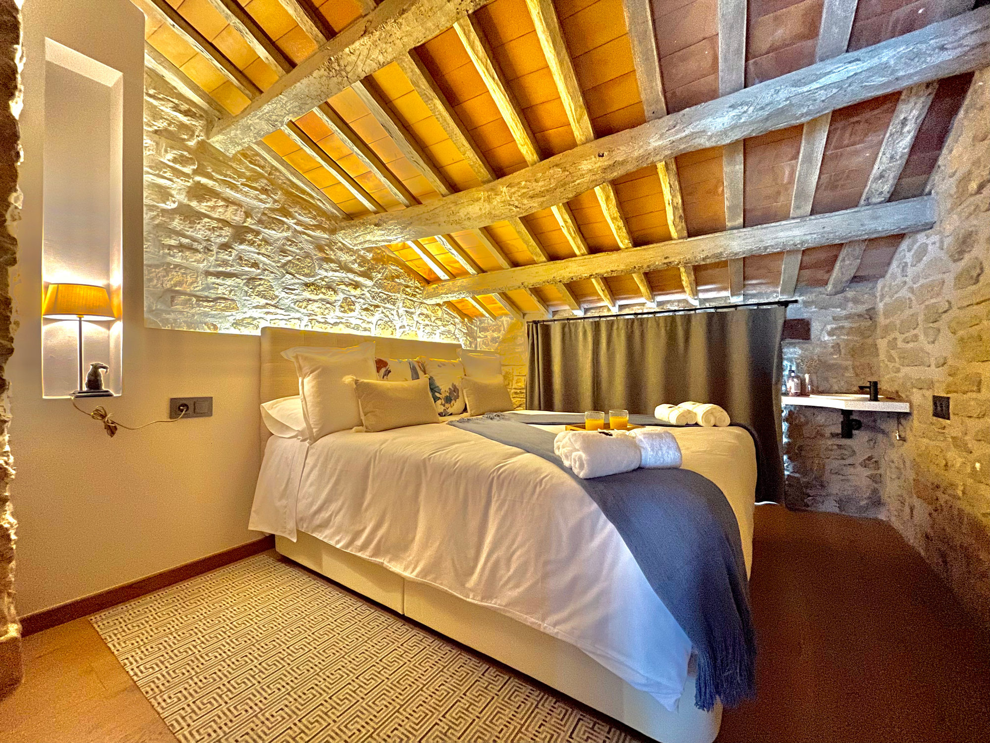 Teulada bedroom at Torre de Queralt, under the wooden-beamed roof